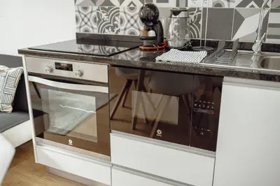 a kitchen with a counter with a dishwasher at Coliseu Apartment by Hosty in Porto