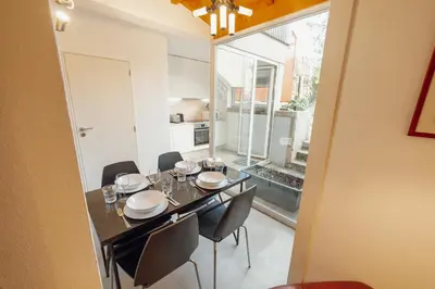 a dining room with a table and some chairs at OPORTO GUEST Luxus Garden in Porto
