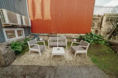 a group of chairs and a table in a yard at OPORTO GUEST Luxus Garden in Porto