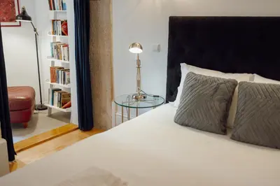 a bedroom with a bed and a glass table at OPORTO GUEST Luxus Garden in Porto