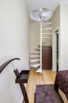 a bedroom with a spiral staircase in a house at PATH Bonjardim Apartments in Porto