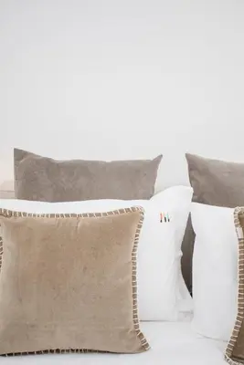 a group of pillows sitting on a bed at NAX Apartments by Liiiving in Porto