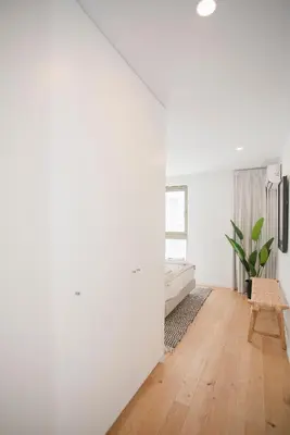 a living room with white walls and wooden floors at NAX Apartments by Liiiving in Porto