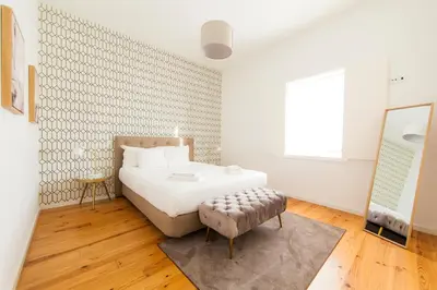 a bedroom with a bed and a chair in it at Citybreak-apartments Sao Bento in Porto