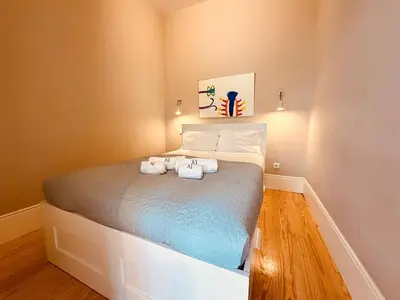 a bedroom with a bed with two towels on it at Art Magellan in Porto