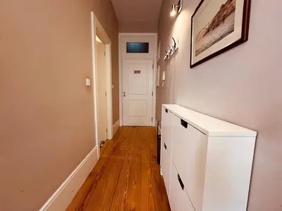 a hallway with white cabinets and a white door at Art Magellan in Porto
