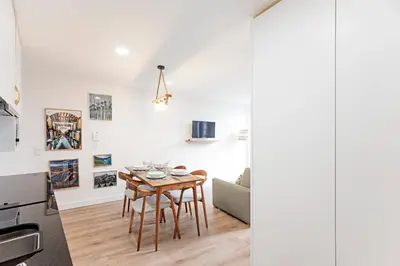 a kitchen and dining room with a table and a couch at Villa Terra The Garden in Vila Nova de Gaia