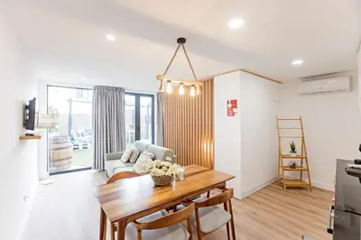a kitchen and living room with a table and a couch at Villa Terra The Garden in Vila Nova de Gaia