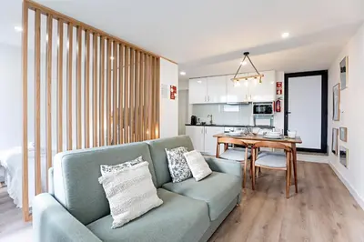 a living room with a couch and a table at Villa Terra The Garden in Vila Nova de Gaia
