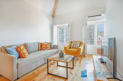 a living room with a couch and a chair at Poveiros Oak Loft - Santo Ildefonso in Porto
