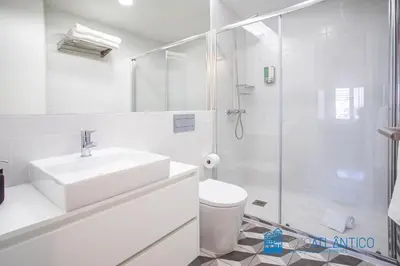 a white bathroom with a sink and a shower at Poveiros Oak Loft - Santo Ildefonso in Porto