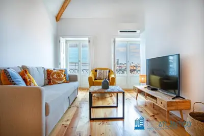 a living room with a couch and a tv at Poveiros Oak Loft - Santo Ildefonso in Porto