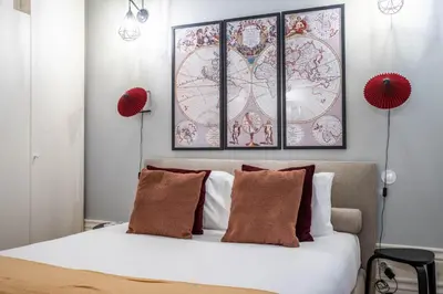 a bedroom with a bed with three pictures on the wall at Sta Catarina 632 by LovelyStay in Porto