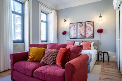 a living room with a purple couch with colorful pillows at Sta Catarina 632 by LovelyStay in Porto