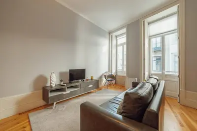 a living room with a couch and a tv at Formosa Deluxe by Hosty in Porto