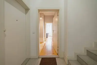 a hallway with white walls and a white stairway at Formosa Deluxe by Hosty in Porto