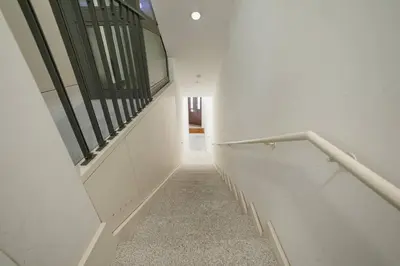 a hallway with white walls and a stair case at Formosa Deluxe by Hosty in Porto