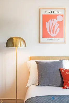 a bedroom with a bed with a lamp and a picture at Boavista Charm Balcony Loft in Porto