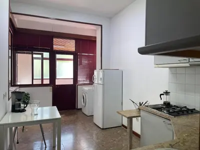 a kitchen with a white refrigerator and a stove at Miguel Bombarda Cozy Apartment in Porto