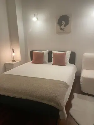a bedroom with a large bed with two pillows at Miguel Bombarda Cozy Apartment in Porto
