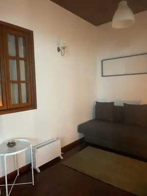 a living room with a couch and a table at Miguel Bombarda Cozy Apartment in Porto