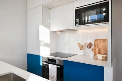 a kitchen with blue and white cabinets and a stove at Quadra Apartment - Luxury & Relaxation in Porto