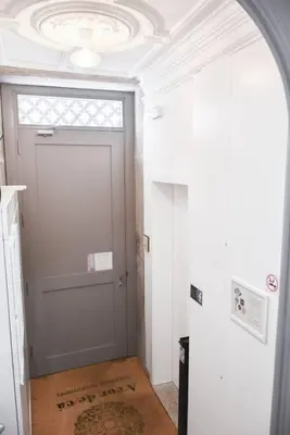 a hallway with a door with a window and a rug at Apartment with balcony in the center of Porto in Porto
