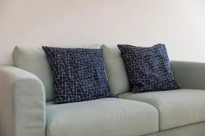 two pillows on a couch in a living room at Clérigos Apartments Porto - Premium in Porto