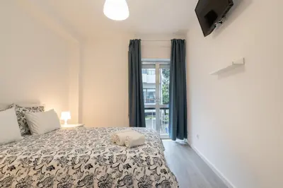 a bedroom with a bed and a tv on a wall at Moreira Terrace in Porto