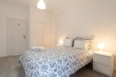 a bedroom with a blue and white bed with two pillows at Moreira Terrace in Porto