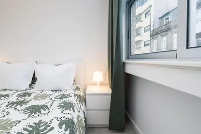 a bedroom with a bed and a window at Moreira Terrace in Porto
