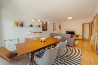 a dining room with a wooden table and chairs at Boavista Premium by Hosty in Porto