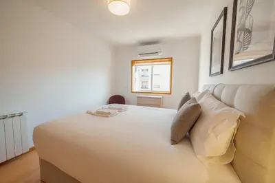 a white bedroom with a bed and a couch at Boavista Premium by Hosty in Porto