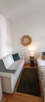 a hallway leading to a bedroom with a wooden floor at Boho House Terrace in Porto