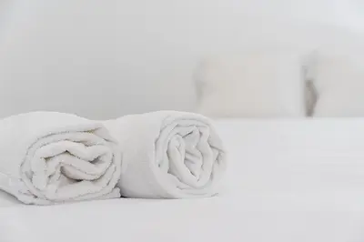 a pile of towels sitting on a shelf at PortoNest Downtown Suites in Porto