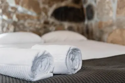 two towels sitting on top of a bed at PortoNest Downtown Suites in Porto