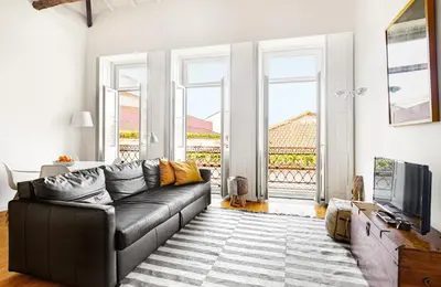 a living room with a couch and a television at Fly me to the Moon in Porto