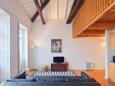 a living room with a couch and a tv at Fly me to the Moon in Porto