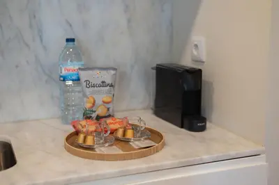 a tray with fruit on a counter with a bottle of water at Cosy House Downtown Porto with swimming pool and AC in Porto