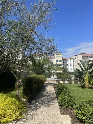 a walkway through a park with trees and buildings at Cosy House Downtown Porto with swimming pool and AC in Porto