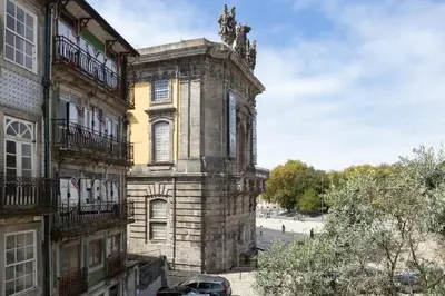 an old building with a statue on top of it at Stunning Clerigos Duplex apartment in the heart of Porto in Porto