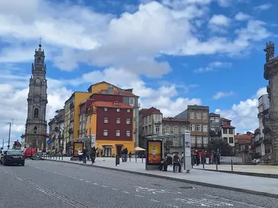 a city street with a clock tower in the distance at Stunning Clerigos Duplex apartment in the heart of Porto in Porto