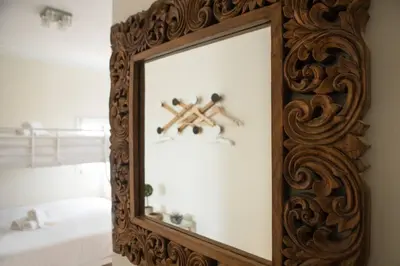 a mirror with a wooden frame in a room at Clerigos Studio Apts in Porto