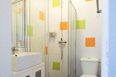 a bathroom with a toilet and a sink and a shower at Clerigos Studio Apts in Porto