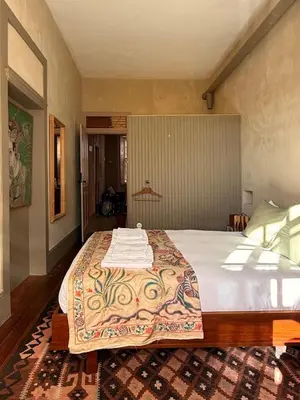 a bedroom with a bed with a blanket on it at Casa Astória - City Centre Historical Building with Amazing River View in Porto