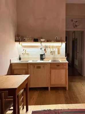 a kitchen with wooden cabinets and a wooden table at Casa Astória - City Centre Historical Building with Amazing River View in Porto