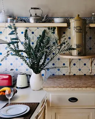 a kitchen with a vase with a plant on the counter at Casa Astória - City Centre Historical Building with Amazing River View in Porto