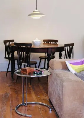 a living room with a table and a couch at Casa Astória - City Centre Historical Building with Amazing River View in Porto