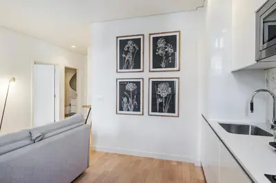 a living room with a couch and some pictures on the wall at GuestReady - A secret passage in Porto in Porto