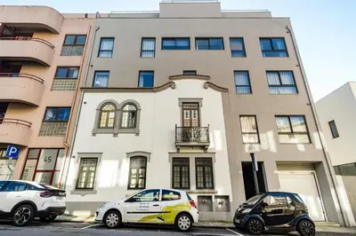 two cars parked in front of a building at GuestReady - A secret passage in Porto in Porto